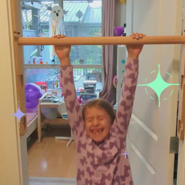 girl does pullups within doorframe